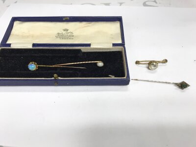 Collection of stick pins including two gold examples set with Opal.