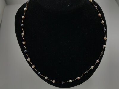 A 14ct gold necklace set with pearls.
3.17g