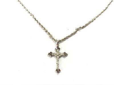An 18ct white gold diamond cross set with white and champagne diamonds on a 14ct rhodium plated chain.
5.27g
