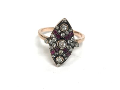An unmarked rose gold navette ring set with diamonds and square cut rubies. Approx 0.34ct diamonds and 0.18ct rubies.
