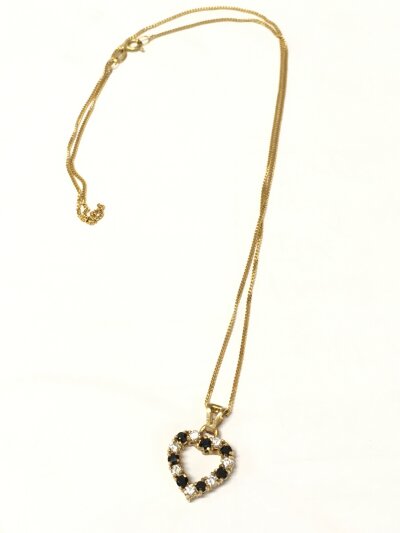 A 9ct gold heart pendant and 9ct chain set with white stones and sapphires. 3.1g total weight