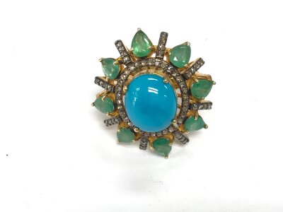 Large cabochon turquoise dress ring set with pear shaped emeralds and small diamonds set in silver gilt.