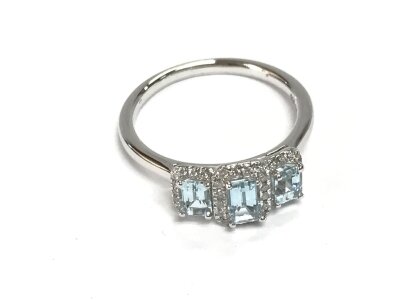 A platinum trilogy cluster ring set with three step cut aquamarines each surrounded by diamonds. Size M