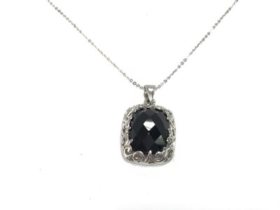 A silver pendant with a large cushion cut checkerboard black onyx on silver chain.