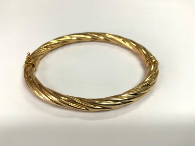 A 9ct gold twist design bangle. 9.1g.