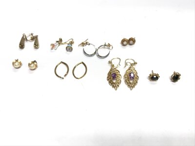 A collection of assorted gold earrings including Opel set studs etc.