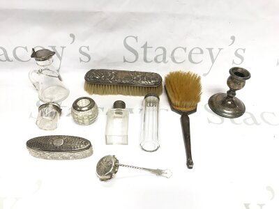 A collection of silver items including brush set glass topped bottles etc.