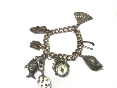 A silver charm bracelet. 30.6g