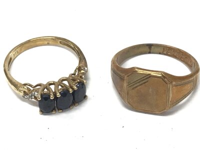 A 9ct gold ring set with dark sapphire type stones and a signet ring, 8.2g total weight. Size P and R.