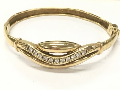 A 9ct gold bangle stone set white cubic zirconias, 13.5g total weight