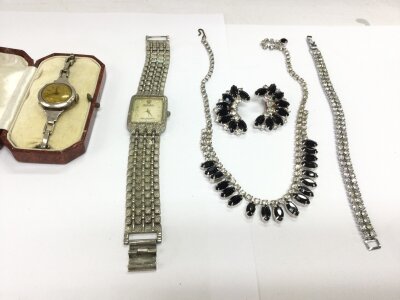 A silver cased vintage watch along with some other items of costume jewellery.