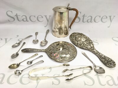 A small collection of silver and silver plated items comprising spoons, hand mirrors etc.