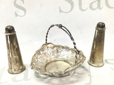 A silver condiment set silver dish with pierced design and handle, silver hallmarked s+p shakers. 9cm tall 11cm wide