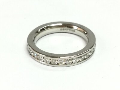 A platinum channel set full eternity ring. Contains 30 x 0.03ct diamonds. Size J 1/2