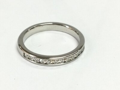 A platinum half eternity ring with channel set diamonds
Size J 1/2 and 3.98g