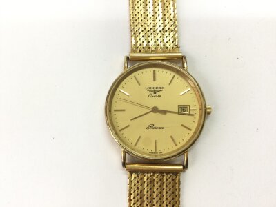 A 9ct cased Longines with an 18ct gold strap and clasp. 
48.85g total