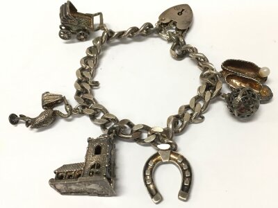 A sterling silver charm bracelet, 50g total weight