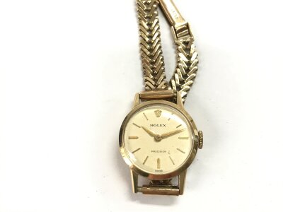 A 9ct gold cased vintage Rolex watch. Is on a 9ct gold strap.
