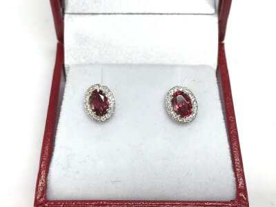 A pair of 9ct white gold pink tourmaline and diamond cluster stud earrings. Tourmaline 1.02ct and 0.19ct diamonds approximately.