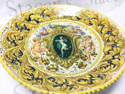 A 19th-century Italian Maiolica charger, lady and putti design. damaged and restored .39cm wide