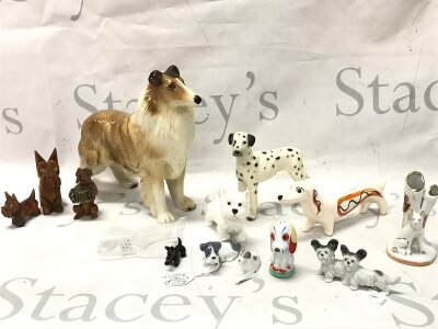 A collection of porcelain dog figures and three wooden examples