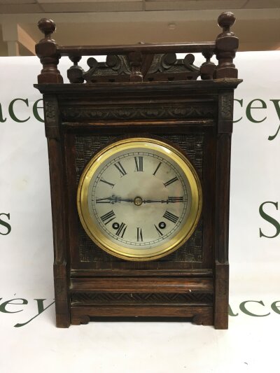 A late Victorian bracket form mantle clock with a carved front.- NO RESERVE