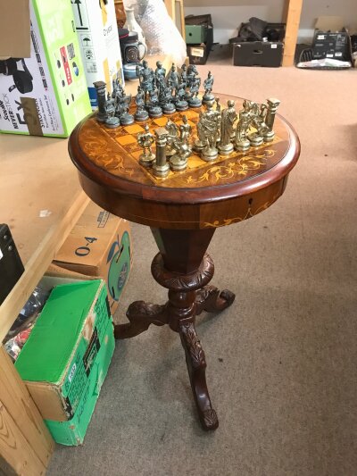 A Victorian walnut games table featuring a circular top with a parquetry inlaid chessboard and floral marquetry. Four pieces missing. 76cm tall, 46cm wide
