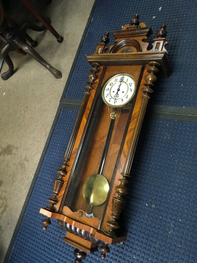 A Walnut Vienna Type  wall clock with pendulum. Approximately 128cm tall