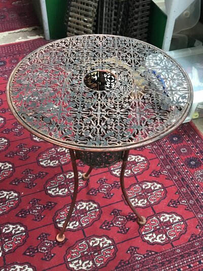A possibly Victorian pierced round metal indoor plant stand with small China feet. 62cm tall 45cm wide