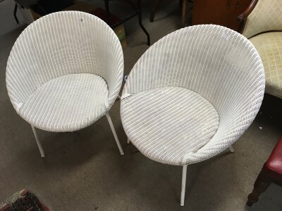 A pair of white Lloyd Loom chairs