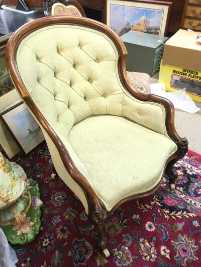 A Victorian walnut armchair with saber legs. Dimensions 65cm wide , 86cm tall, 85cm deep