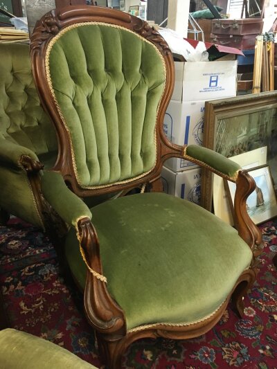 A Victorian open armchair with a damaged leg. 108cm tall, 68cm wide 58cm deep