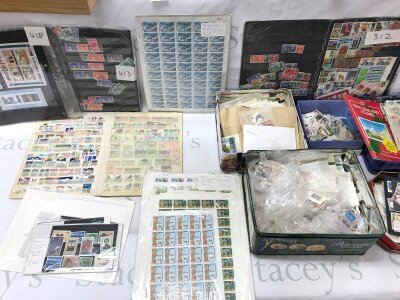 A large collection of assorted stamps including complete mint sheets.- NO RESERVE