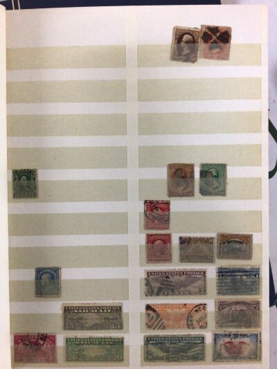 Four albums containing stamps including early United States Early Victorian Edward VII and later British stamps mainly used.
