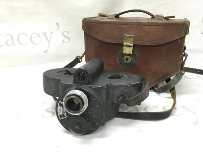 A vintage Bell and Howell filmo automatic cine camera in a leather case