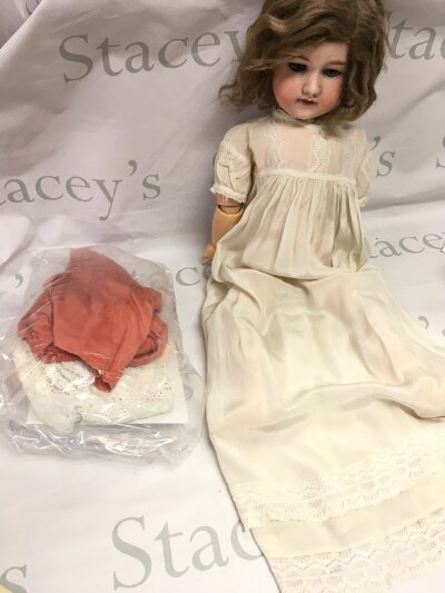 An early 20th century German Bisque head doll by Armand Marseille , with extra clothes.- NO RESERVE