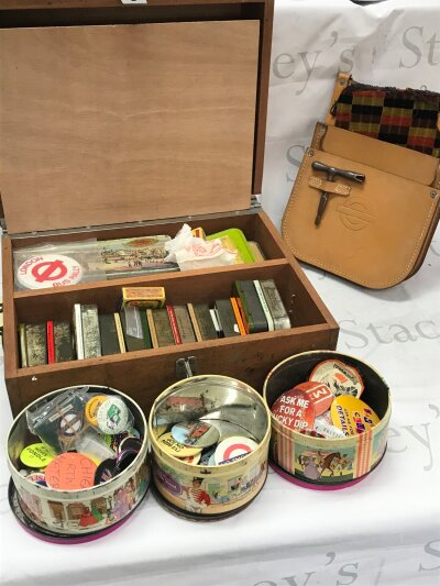 A box containing a large collection of vintage badges including London transport underground and buses enamel badges  , with a London Transport bus conductors leather satchel