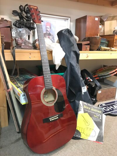 An acoustic Stagg guitar in good condition, full size 103cm and guitar jazz book