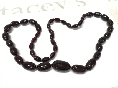A cherry red amber or Bakelite style necklace , 80cm , 84g