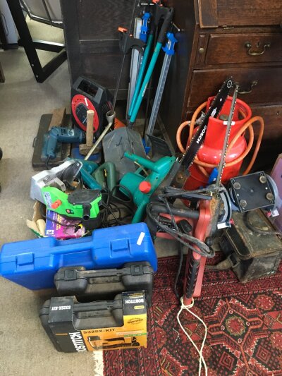 A collection of tools and equipment including an Oregon double guard chainsaw, Bosch AKE 40 chainsaw, Florabest chain sharpener , Makita drill etc
