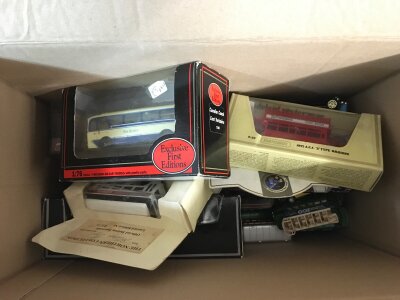 A box including yesteryear buses and other diecast buses