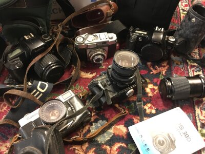 Vintage cameras including a Canon EOS 1000F, Zeiss Contina, Canon EOS 500, Canon Canonet