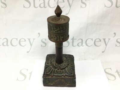A Tibetan prayer wheel and carved stand