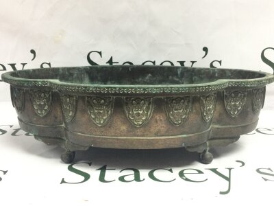 A Japanese bronze jardiniere , decorated with embossed motifs and four character mark stamped at base. 43cm wide 12.5Cm tall
