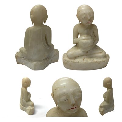 18th Century figure of a seated Burmese monk holding an alms bowl, Shin Thiwali carved in marble. 20cm.