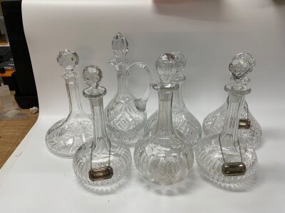 5 cut glass vintage decanters with 3 hallmarked silver drinks labels.