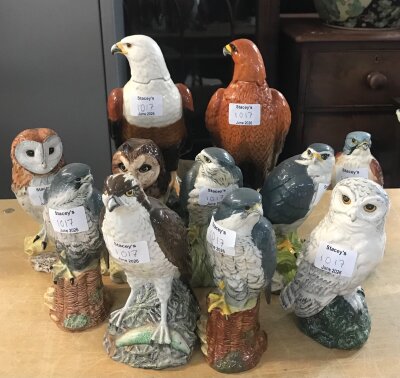 A group of 11 ceramic bird figurines: Peregine falcons, Snowy owl, Barn owl, brown owl/ tawny owl, eagle or hawk, pheasant or partridge. Late 20th century decorative ceramics roughly 1970s to 2000s, made using slip cast ceramic molds and hand painted decoration. (no obvious damage and recreation)