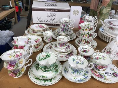 A collection of Royal Doulton Months of the Year tea sets- including side plates, cups and saucers