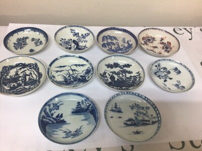 A collection of ten 18th English porcelain saucer dishes nine with underglaze blue patterned of the Chinese influence and one polychrome dish. Some minor hairline cracks most in good condition (10)