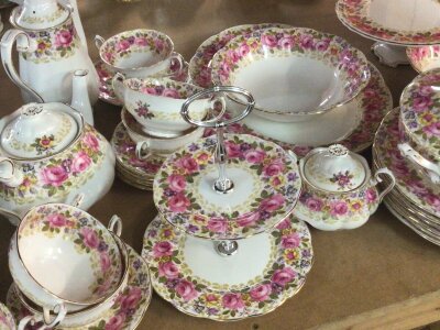 An Extensive Royal Albert English porcelain Serena pattern dinner and tea and coffee service. decorated with bands of pink roses. Comprising plates of mixed sizes cups both coffee and tea including pots for both servings two tureens a two tier cake stand a cake comport cream jug milk jug soup bowls and more no obvious damage.